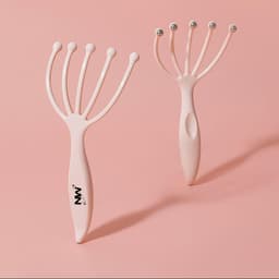 A pink head massager with multiple prongs and ball tips. The product features a logo on its handle.