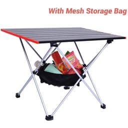 A portable camping table with a black top, red edges, and a mesh storage bag underneath filled with items.