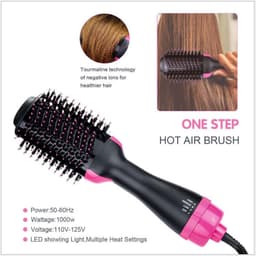 A hot air brush in black and pink features a round brush head and a handle, designed for personal hair care.