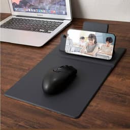 A grey multi-function mouse pad with a wireless charging feature, a mouse, and a smartphone stand.