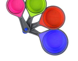 A set of silicone measuring cups in pink, green, red, and blue, featuring a grey handle and a logo.