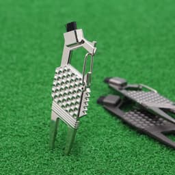 A silver 7-in-1 golf tool featuring various functions, set against a green grass background.