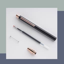 A black and rose gold metal push-up pen with a removable nib and a spring.