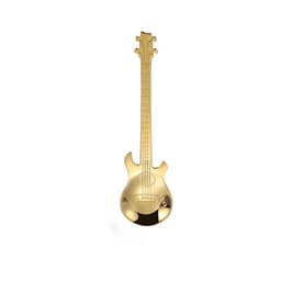 A gold guitar-shaped spoon with detailed design features and a logo on the surface.