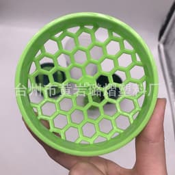A green fitness shaker cup with a honeycomb design for efficient mixing, featuring a logo on its surface.