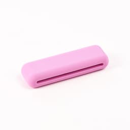 A pink silicone weighted bracelet with a smooth surface and a slot running through the centre.