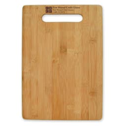 A large bamboo cutting board with a handle cutout, featuring a smooth surface and natural wood grain.