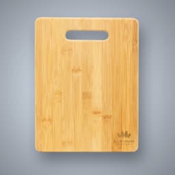 A large bamboo cutting board with a handle cutout, featuring a natural wood finish and a logo on the bottom corner.