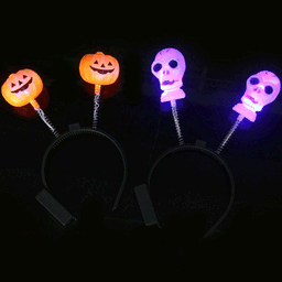 Flashing LED headband with orange pumpkin and purple skull decorations, featuring a spring attachment.