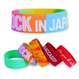 A collection of silicone wristbands in various colours, featuring different designs and a logo on one wristband.