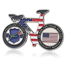 A decorative coin featuring a bicycle design, with blue and red colours, a shield, and a flag motif.