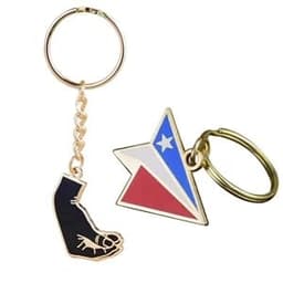A hard enamel keychain featuring a black foot design and a star-shaped emblem in red, white, and blue, attached to a gold chain.