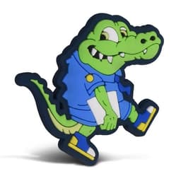 A green crocodile PVC lapel pin with a smiling expression, wearing a blue shirt and blue shoes, featuring a logo.