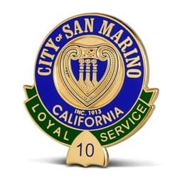 A gold and blue lapel pin featuring a shield with a harp design, labelled "City of San Marino, California" and "Loyal Service".