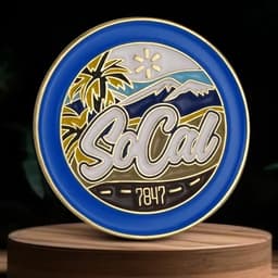 A blue and gold lapel pin featuring palm trees and mountains with "SoCal" and "7847" designs.