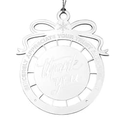 A silver cut-out ornament featuring a decorative bow and the words "thank you" in an elegant font.