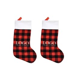 A large plaid Christmas stocking ornament in red and black with a white cuff and a branding logo.