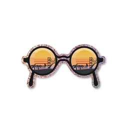 Glitter stickers in the shape of sunglasses with sunset reflections and palm trees, featuring a vibrant colour palette.