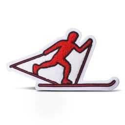A red chenille patch featuring a skier design on a white background, with black outlines.
