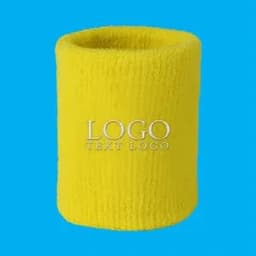 A yellow Terry sweatband wristband with an embroidered logo featured on a bright blue background.