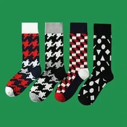 A set of four pairs of mid-calf crew cotton socks featuring various patterns in red, black, and white.