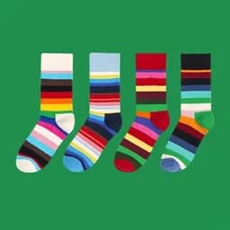 A set of four unisex crew socks in assorted bright colours and patterns, featuring stripes and a variety of hues.