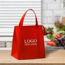 A red foldable cooler bag with handles, featuring a logo on its front, placed on a kitchen countertop.