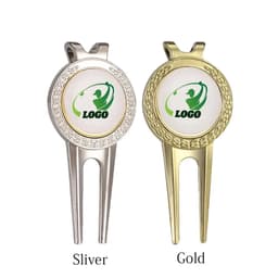 A silver and a gold golf divot tool with ball markers, featuring a logo on each marker.