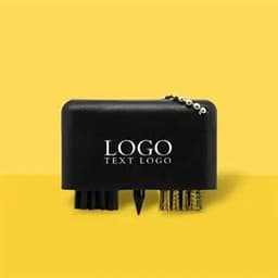 A black plastic golf brush keychain featuring brushes and a small spike, accompanied by a logo.