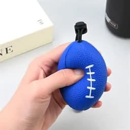 A blue stress relief grip ball shaped like a rugby ball, featuring a white stitch design and a black rope attachment.