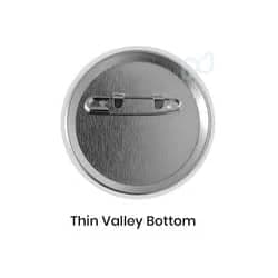 A metallic circle button featuring a thin valley bottom and a pinback for attachment.