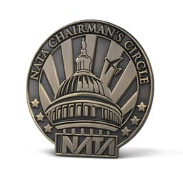 A die struck pin featuring a bronze finish with a prominent dome design and an emblem. It includes a logo.
