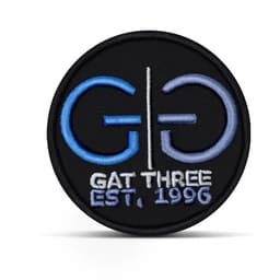 A round, black 3D embroidered patch featuring a logo in blue and white, with 'GAT THREE EST. 1996' text.