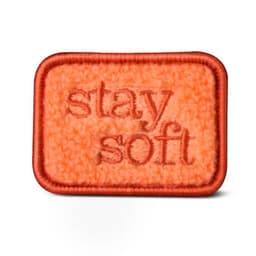 An orange chenille patch with a textured surface and embroidered text, featuring a brown border.