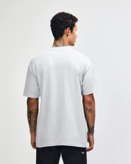 A grey heavyweight cotton unisex T-shirt displayed from the back, worn by a model. The shirt has a simple design.