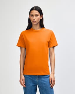 An orange heavyweight cotton unisex T-shirt is displayed, featuring a simple design and a logo.