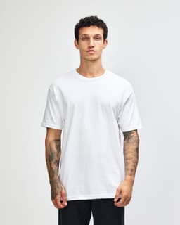 A lightweight unisex t-shirt in white, featuring a round neck and short sleeves, displayed on a model.