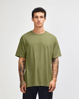 A unisex heavyweight cotton t-shirt in olive green, featuring a relaxed fit and short sleeves. It includes a logo.