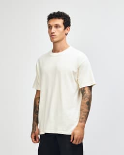 A unisex garment dyed heavyweight cotton t-shirt in off-white, featuring a casual fit and short sleeves.