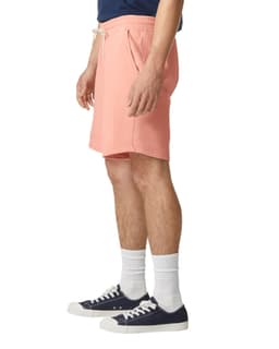 Lightweight sweatshorts in a coral colour, featuring an elastic waistband and side pockets, displayed on a model.