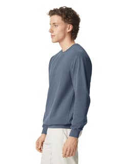 A crewneck sweatshirt in a shade of blue, featuring long sleeves and a logo.