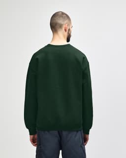 A dark green Gildan Heavy Blend adult crewneck sweatshirt, showing the back view, with long sleeves and a plain design.