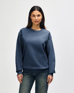 A crewneck sweatshirt in a blue hue, featuring long sleeves and a relaxed fit. It includes a logo on the garment.