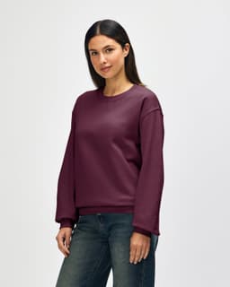 A burgundy Gildan Heavy Blend adult crewneck sweatshirt displayed on a model, featuring a simple design.
