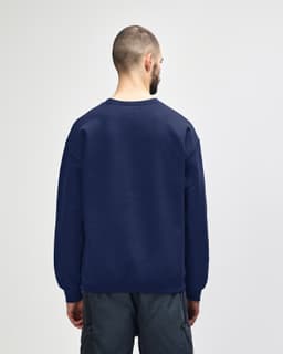 A navy Gildan Heavy Blend adult crewneck sweatshirt, showcased from the back, with a casual fit and long sleeves.