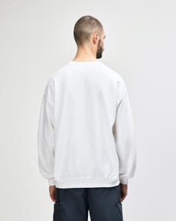 A white Gildan Heavy Blend adult crewneck sweatshirt seen from the back, featuring a plain design and a logo.