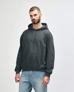 A grey hooded sweatshirt with a front pocket and drawstring details, worn by a model standing casually.