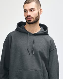 A dark grey hooded sweatshirt is displayed, featuring a model with long hair and a subtle smile.
