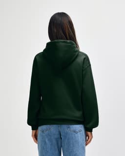 A green hooded sweatshirt with a back view, featuring a logo, paired with blue jeans.