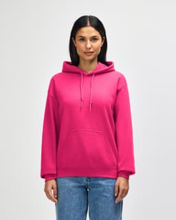 A pink Gildan Heavy Blend adult hooded sweatshirt with a front pocket and a hood. The model stands in a neutral background.